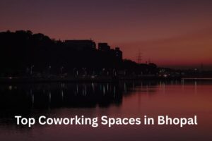 A silhouette of Bhopal's skyline at sunset over a lake, with text reading "Top Coworking Spaces in Bhopal."