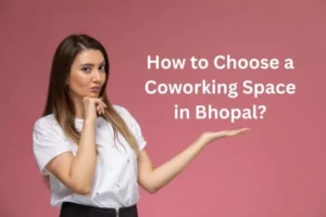A woman in a white shirt thinking about how to choose a coworking space in Bhopal on a pink backdrop.