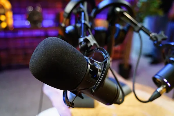 High-quality condenser microphone with pop filter and professional podcast equipment ready for recording sessions.