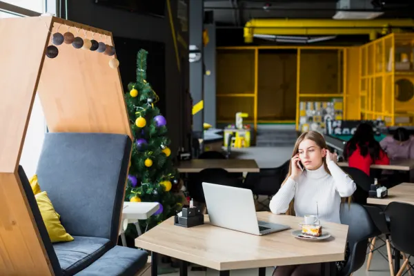 Freelancer working in a modern coworking office featuring comfortable seating, collaborative zones, and quiet workspaces.