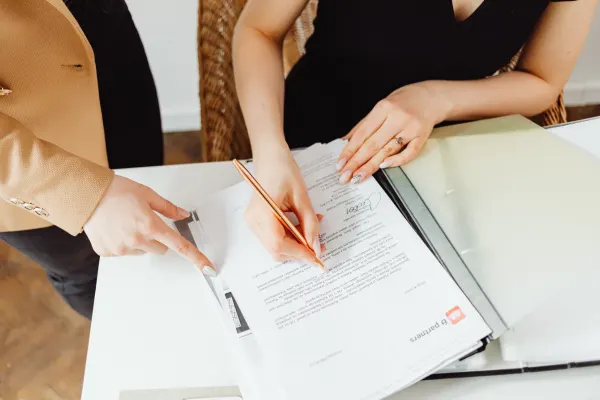 Signing legal documents to Register Your Business using a coworking space address for a professional business setup.