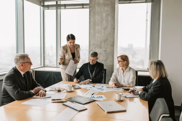 Professionals meeting in a coworking office to Register Your Business with a credible commercial business address.