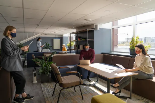 Shared Office Spaces with professionals working in a modern coworking office filled with natural light setting